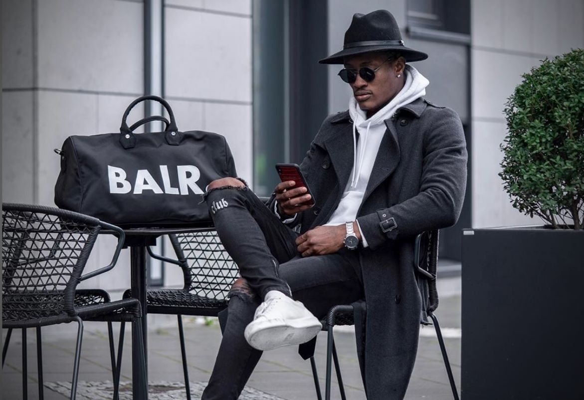 man wearing a hat sitting at a table