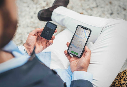 man holding tracking device for wallets and iphone