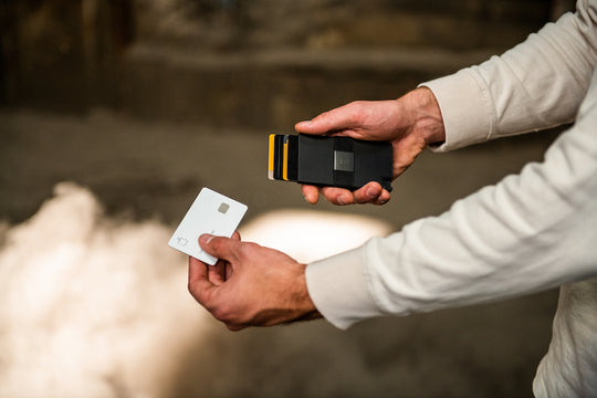 man removing card from metal wallet