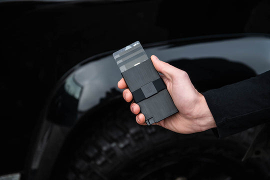 Person fanning cards from aluminum cardholder