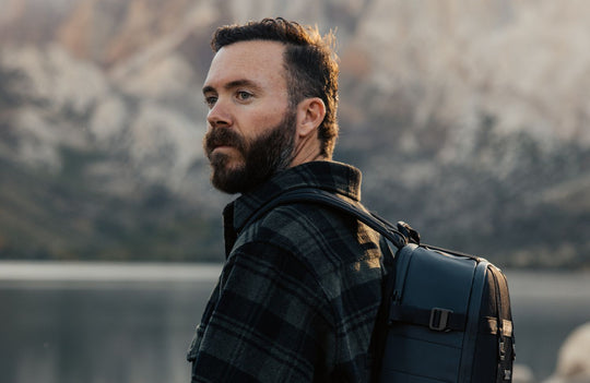 Image of Morgan Oliver-Allen looking towards nature with the mountains as a backdrop 
