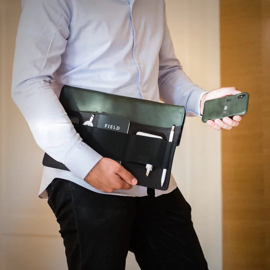 Laptop Sleeve held by man under arm with matching iPhone