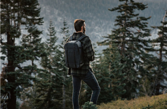 Image of Morgan Oliver-Allen at the top of a mountain, wearing an Ekster backpack 