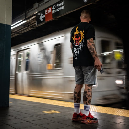 Man waiting on metro with wallet in hand 