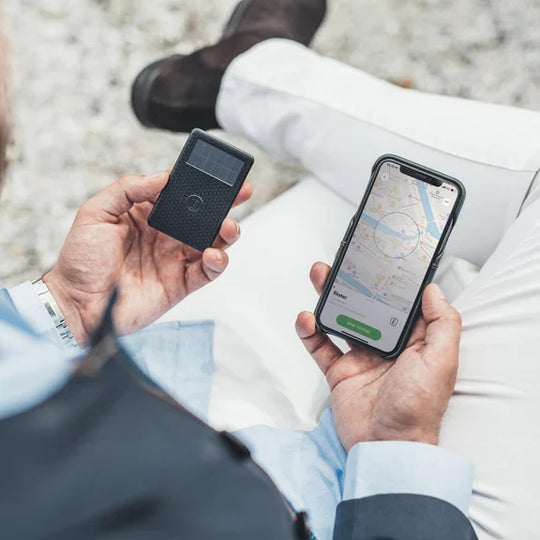 Tracker Card with solar panel and app on phone in hand 