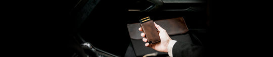 Person holding Ekster Parliament leather wallet with easy access card storage