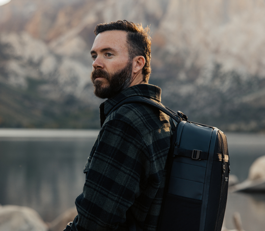 Image of Morgan Oliver-Allen looking towards nature with the mountains as a backdrop 